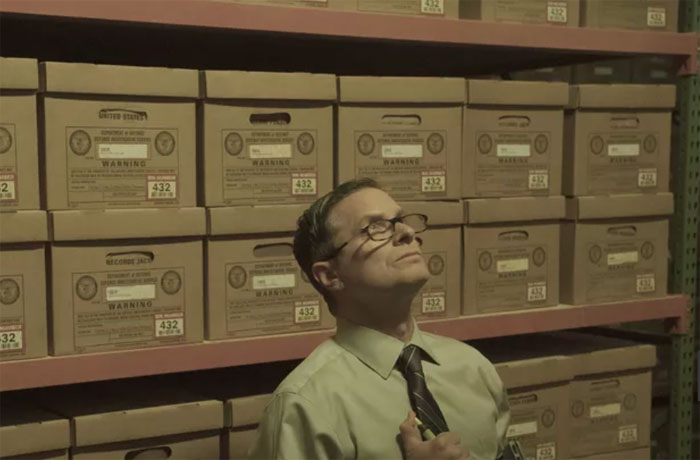 man looking at files