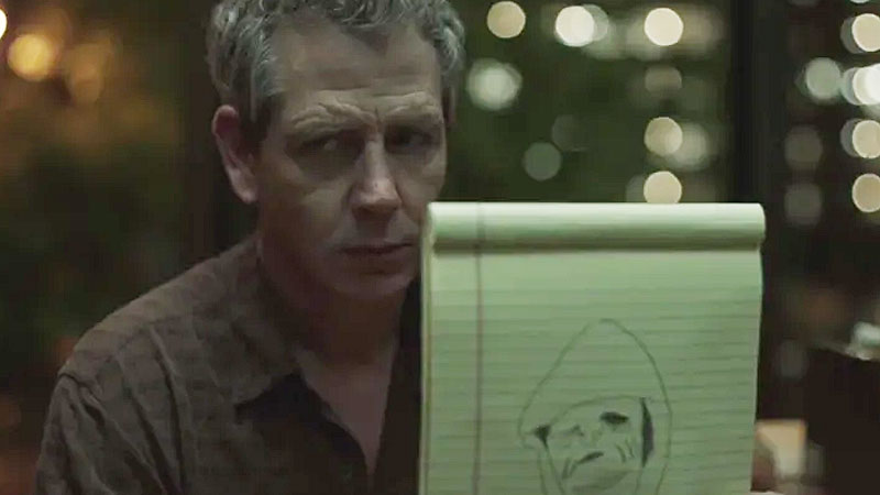 Ralph holding up monster drawing in The Outsider TV show.